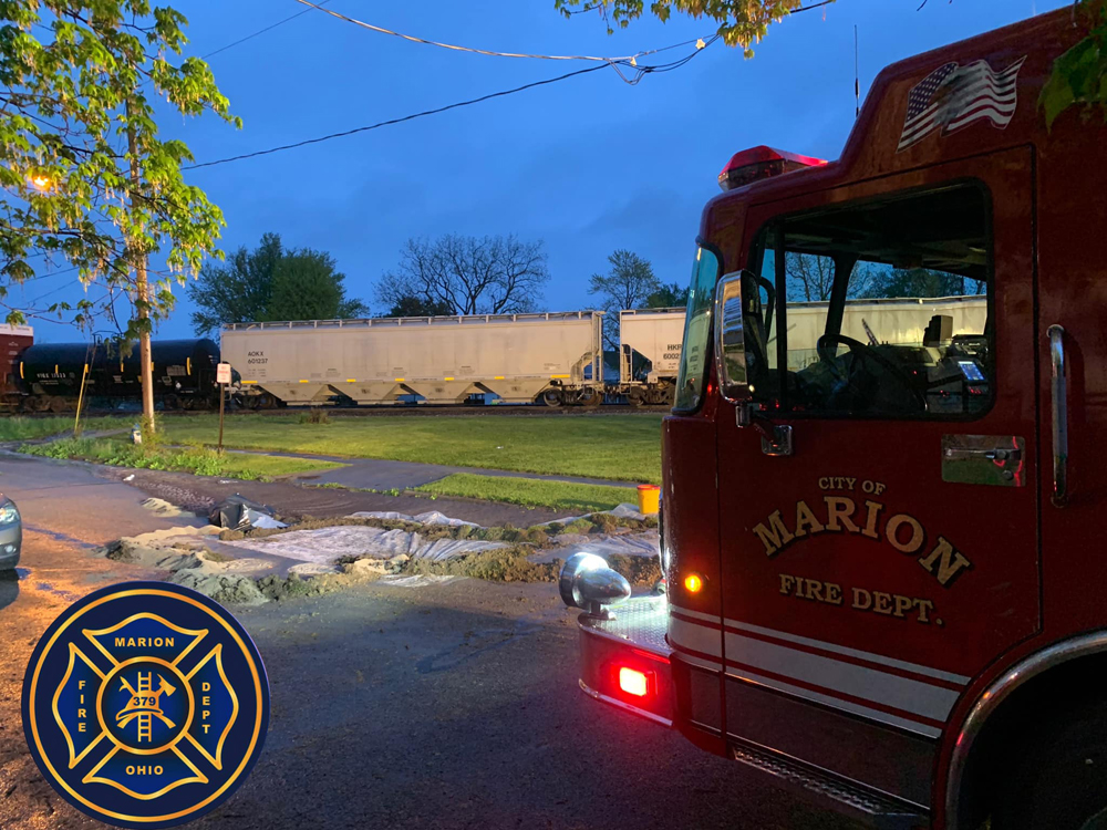 Fire truck parked near freight train