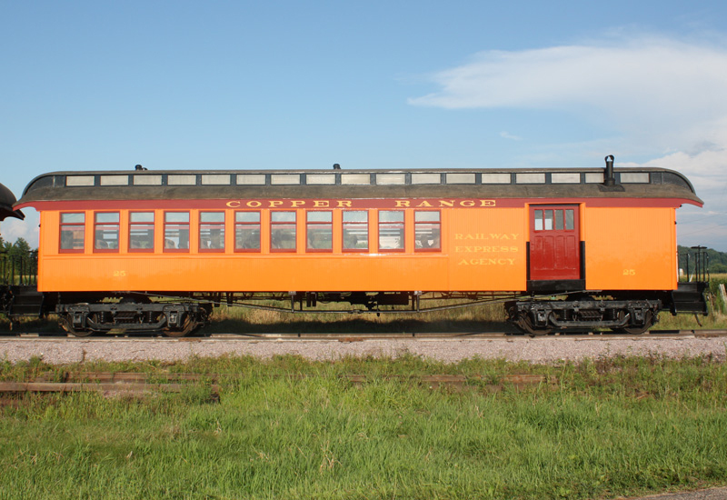 Orange wooden passenger car with red door