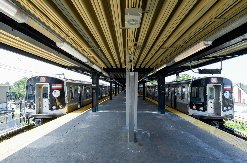 Two subway trains at open-air station