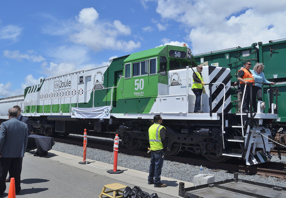 Green and white locomotive with black stripes on nose