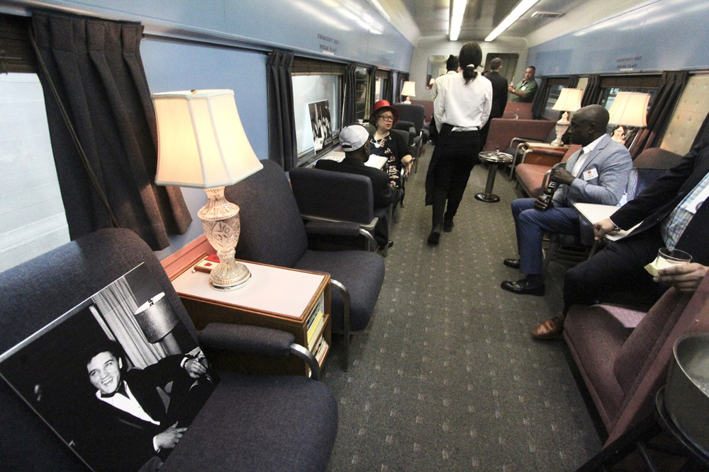 Interior of vintage passenger car, with photo of Elvis Presley on seat nearest camera