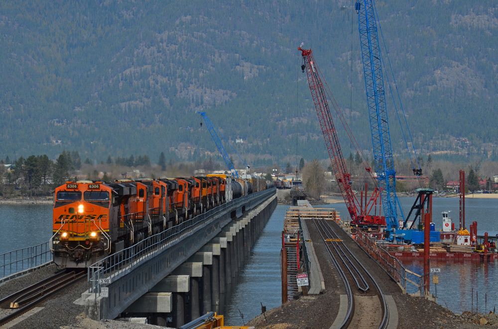 Train on bridge, with work in progress on adjacent bridge