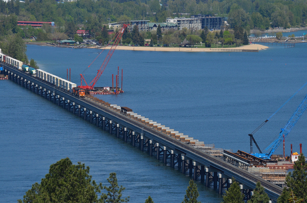 High-angle view of train on bridge with adjacent bridge under reconstruction