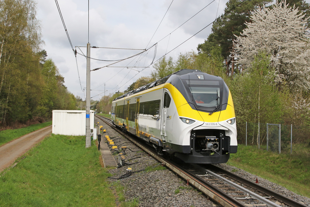 Yellow and white multiple-unit trainset on straight track