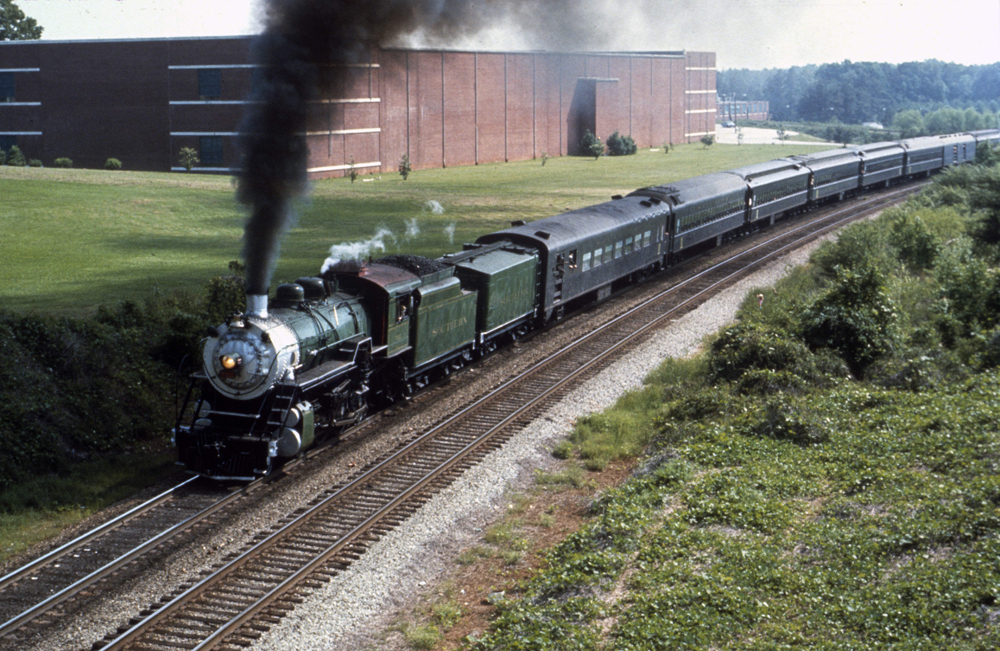 Overhead view of steam locomotive with green paint scheme on fan trip