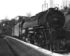 Smoking steam locomotive with freight train