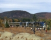 Silver-and-blue diesel Delaware & Hudson locomotives with passenger train surrounded by people