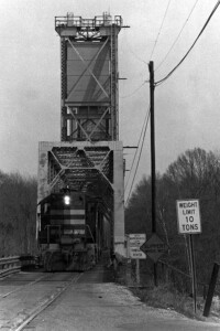 Black Meridian & Bigbee Railroad diesel locomotive coming off end of bridge