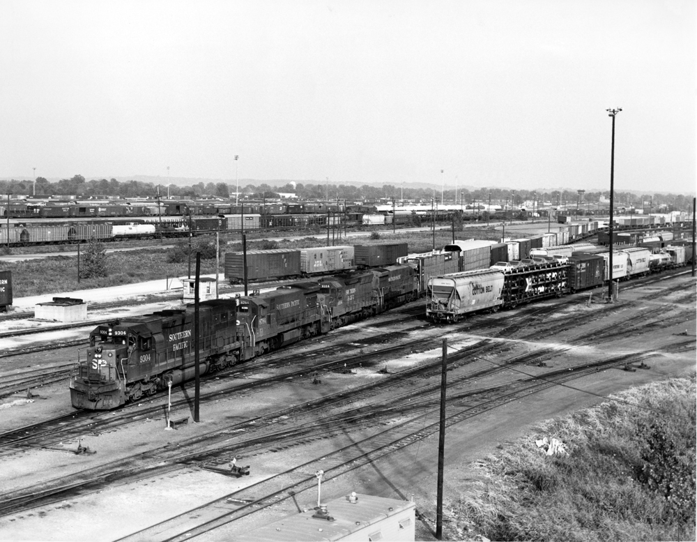 Four diesel locomotives on freight train in yard