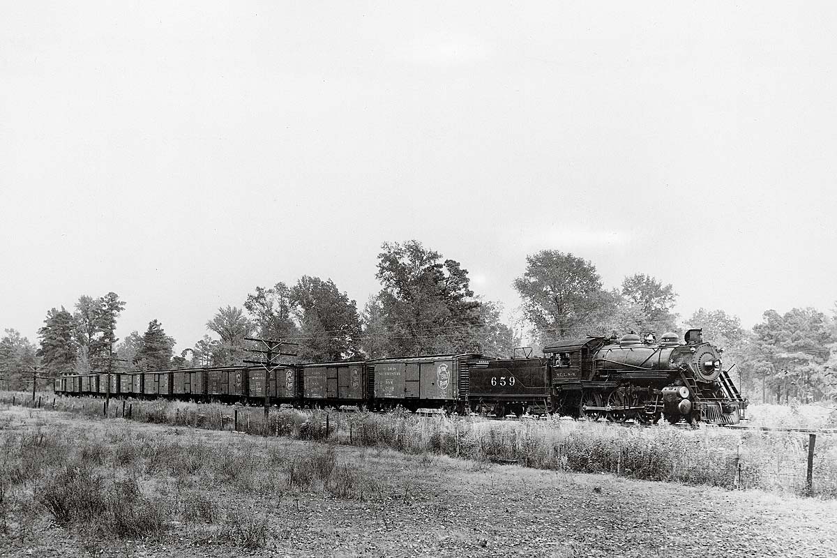 Steam locomotive with Blue Streak Merchandise freight train across field