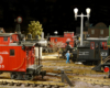 night scene in a model locomotive yard in garden railway