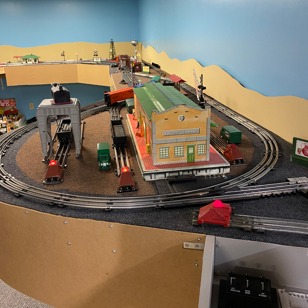 section of toy train layout with track and structure