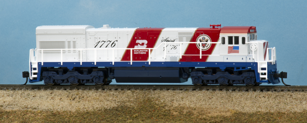 Color photo of N scale diesel locomotive on scenic base.