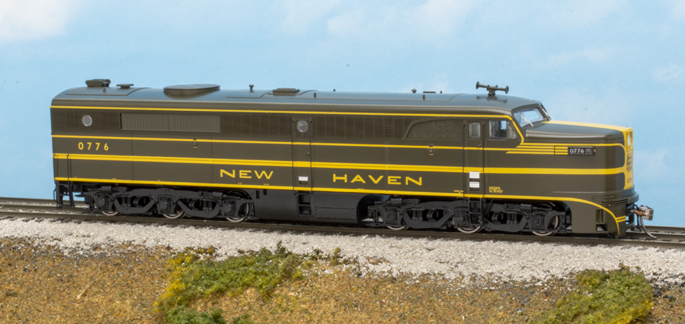 Color photo of HO scale passenger engine in green and yellow paint.