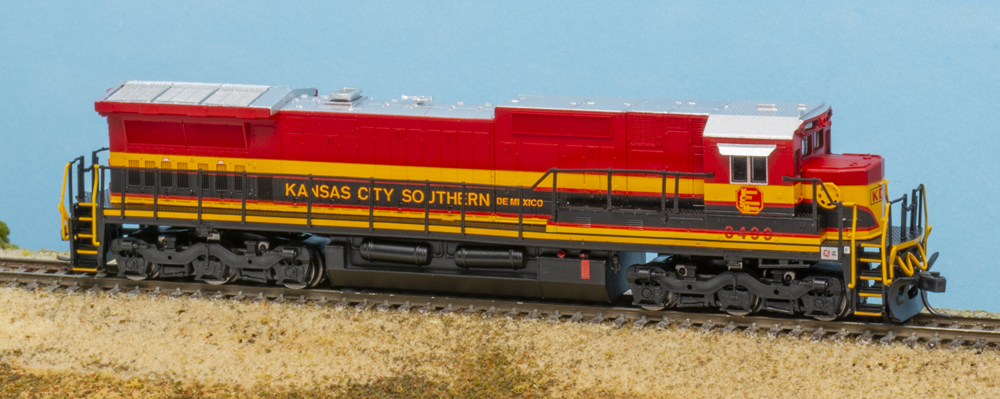 Color photo of N scale road locomotive in red, yellow, and black paint.