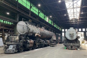 Steam locomotives inside shop building