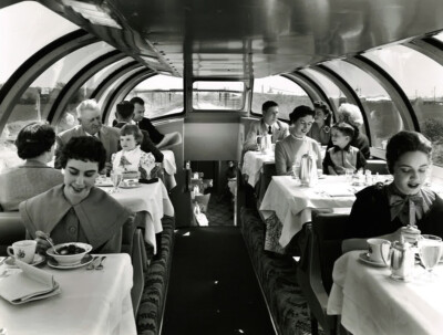 Black and white photo of passengers eating a meal in the dome of a Union Pacific dome-diner.