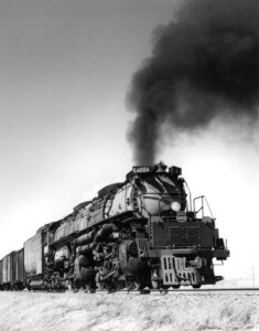 Black and white photo of a large steam locomotive with a huge smoke plume. More of the Big Boy story