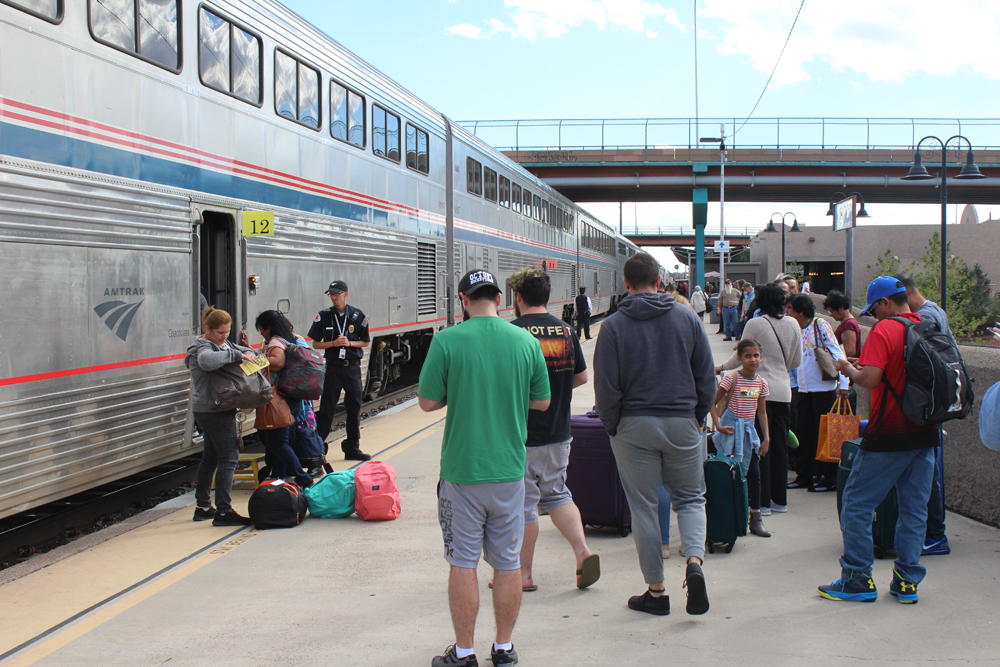 people waiting to board train