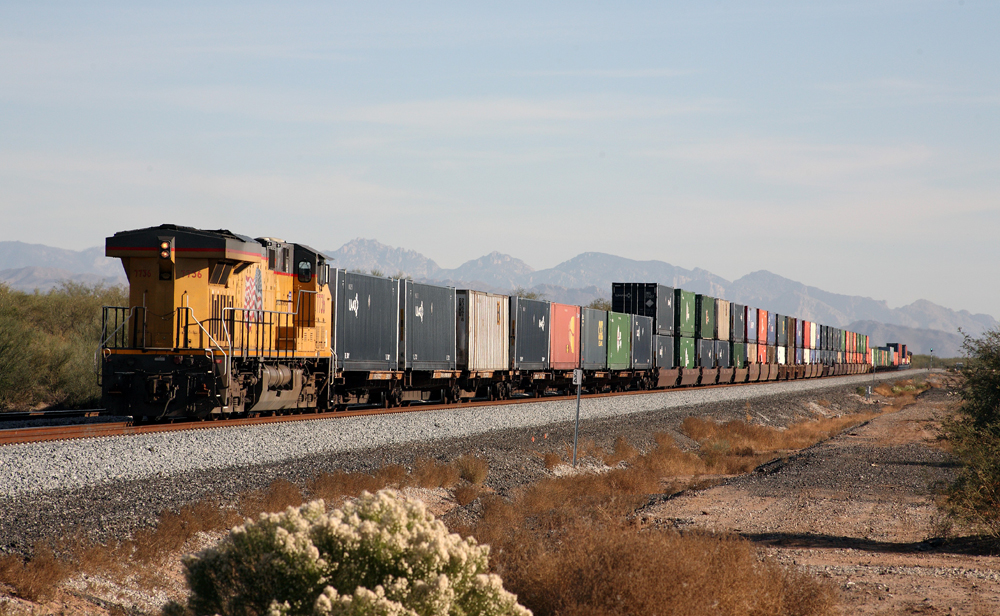 train moving eastbound with two units up front and one on the back
