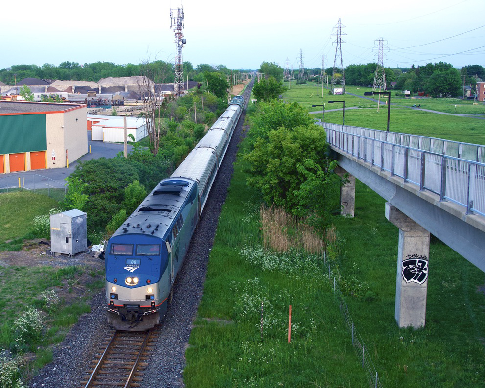 Passenger train viewed from pedestrian overpass