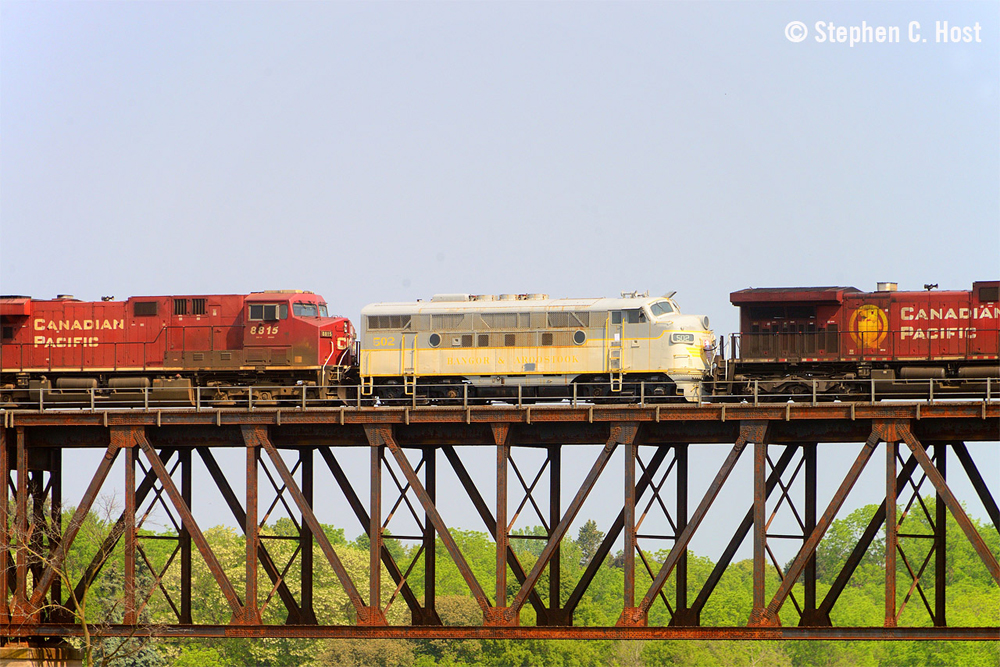 F3A locomotive in vintage paint scheme on bridge