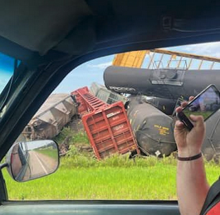 Shot through vehicle window of derailed railcars