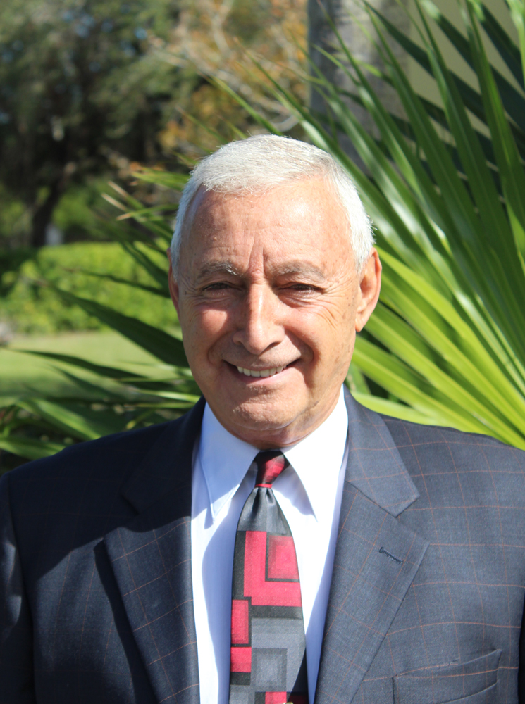 Man standing in front of palm tree