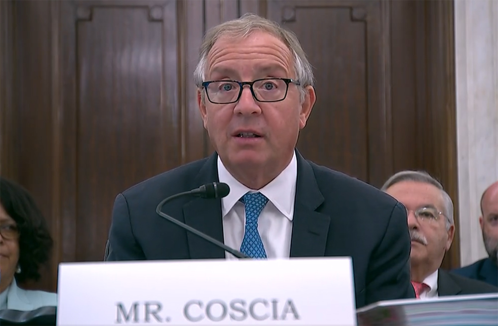 Man at table in congressional hearing room