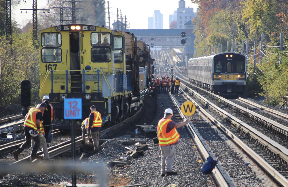 Track workers wait to work as commuter train passes