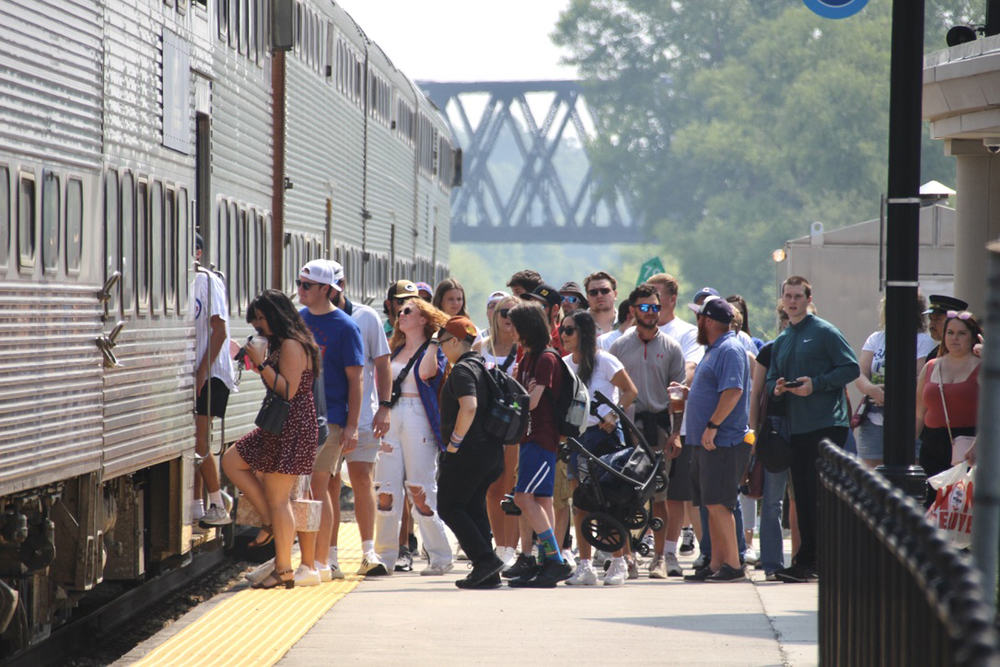 Large number of people waiting to board commuter train