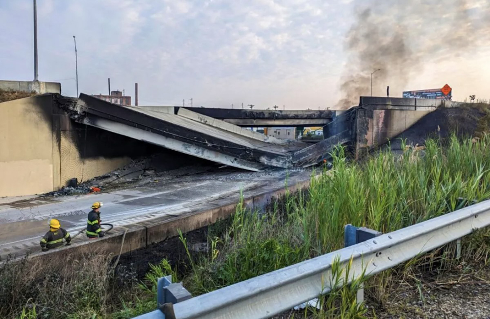 Smoke rises from collapsed freeway bridge