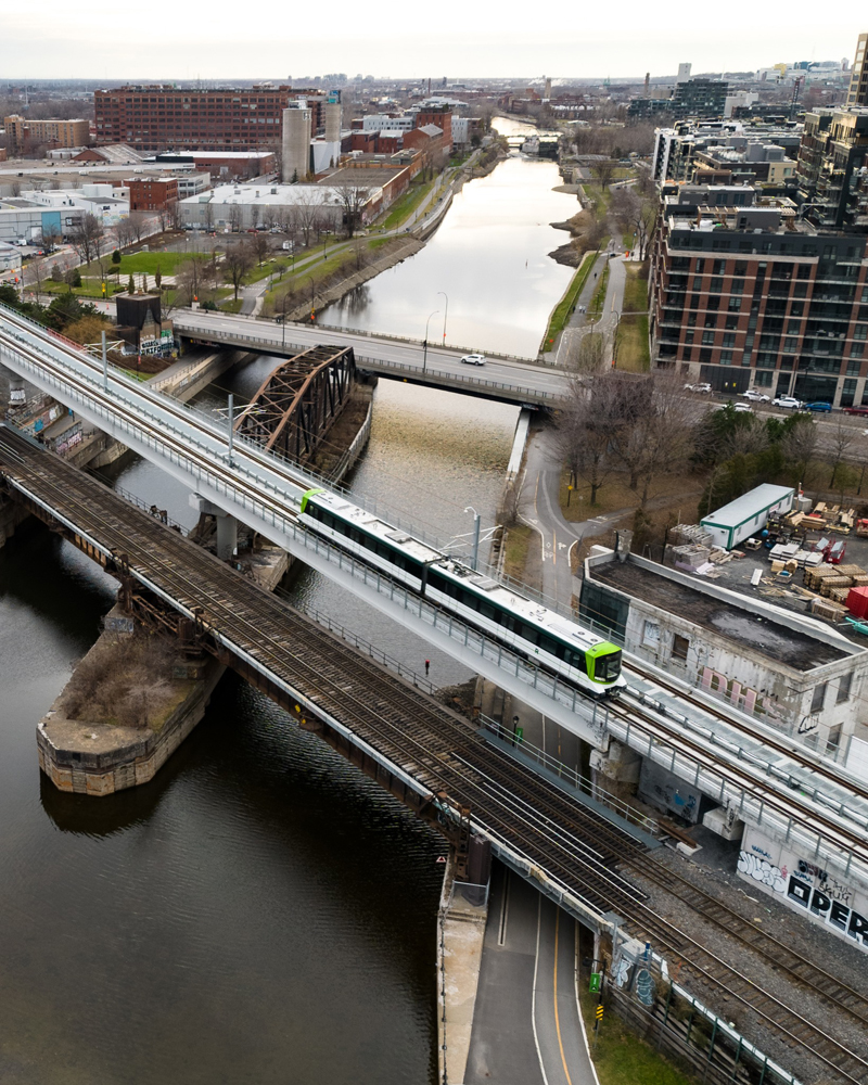 Aerial view of two-car light rail train on bridge