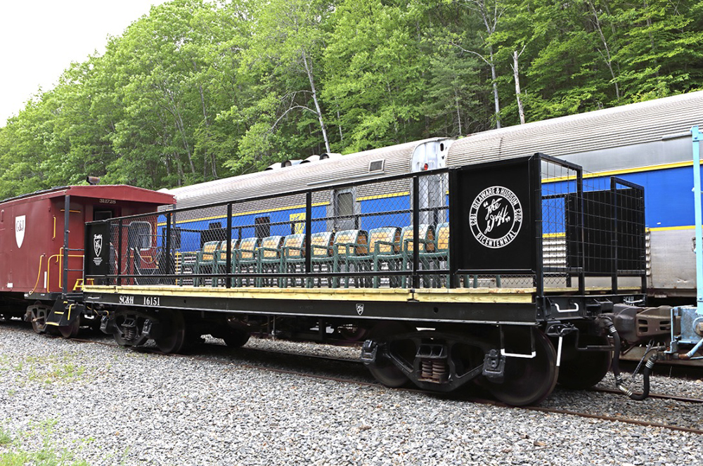 Flatcar with railings and seats added for open-air passenger use