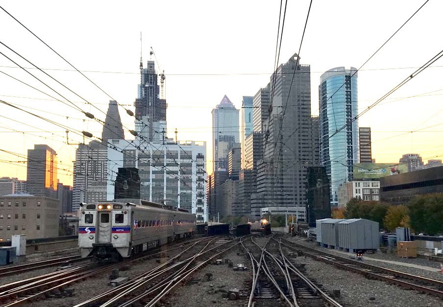 SEPTA train near sunset with Philadelphia skyline in background