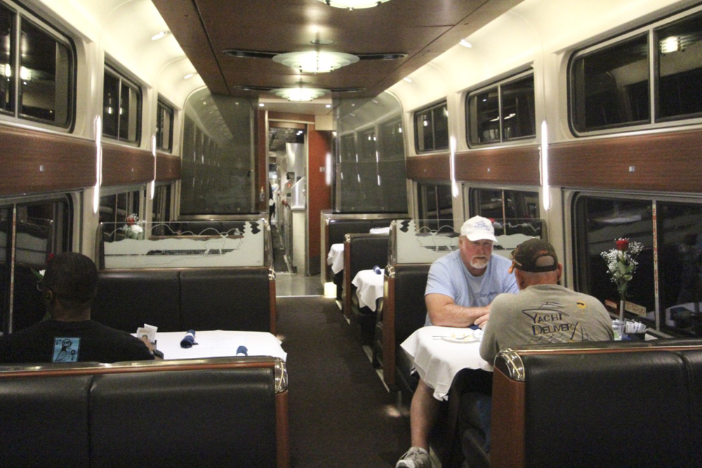 A few people eating in dining car.