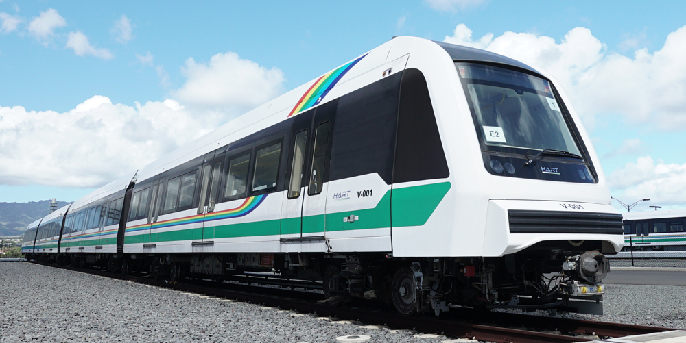 Three-quarter view of white four-car light-rail trainset