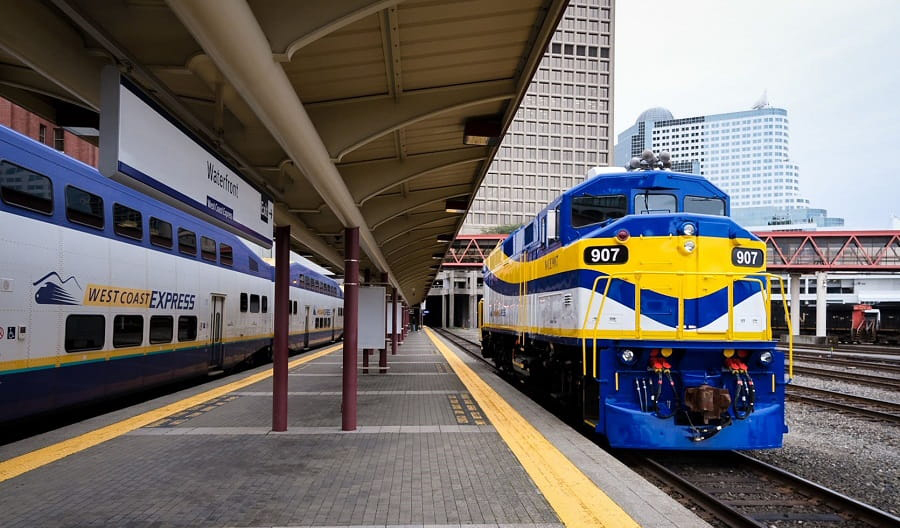 Blue, yellow, and white locomotive at station