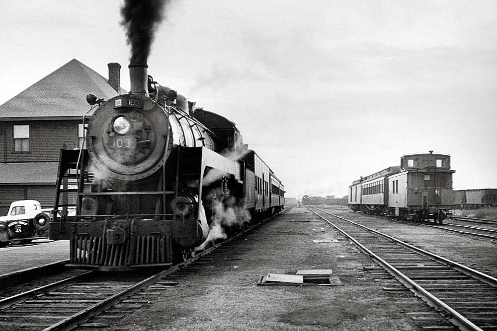 Example of steam Algoma Central locomotives with passenger train by station