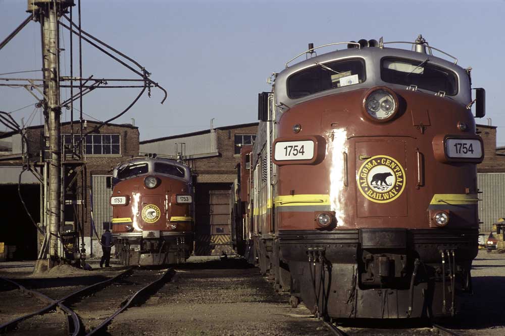 Gray-and-maroon streamlined diesel Algoma Central locomotives