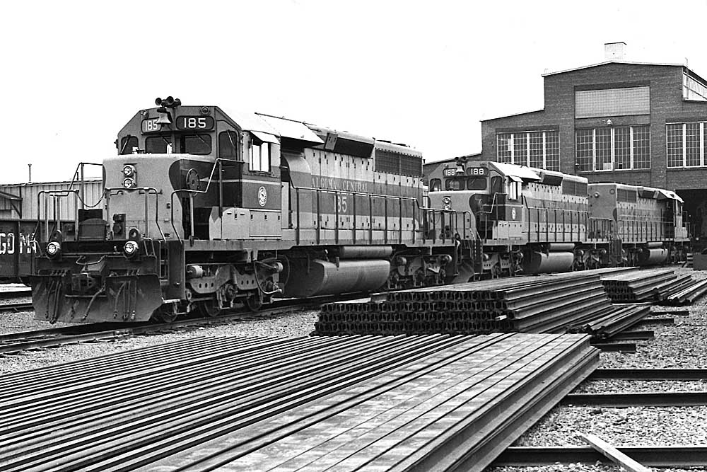Striped Algoma Central locomotives in yard