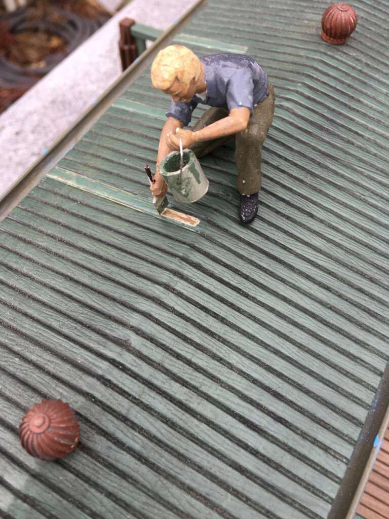 model figure on roof of structure