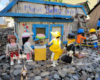 model people gather outside of a bakery shop