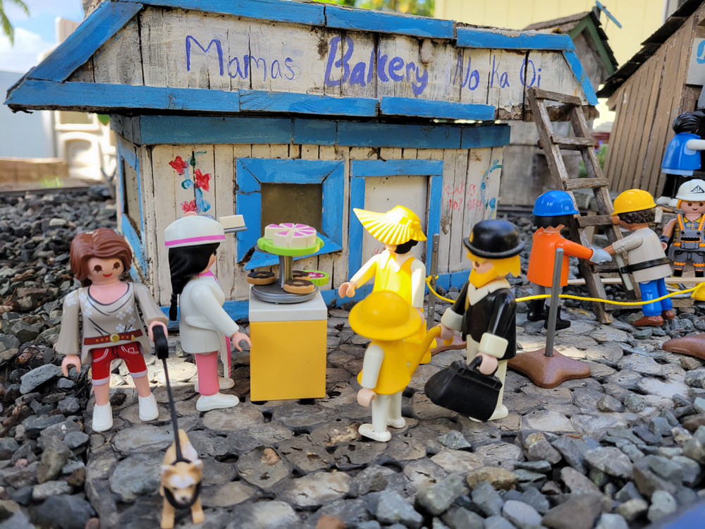 model people gather outside of a bakery shop