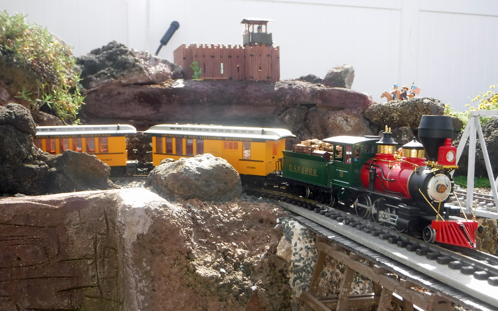 steam engine with train on curve of garden railway