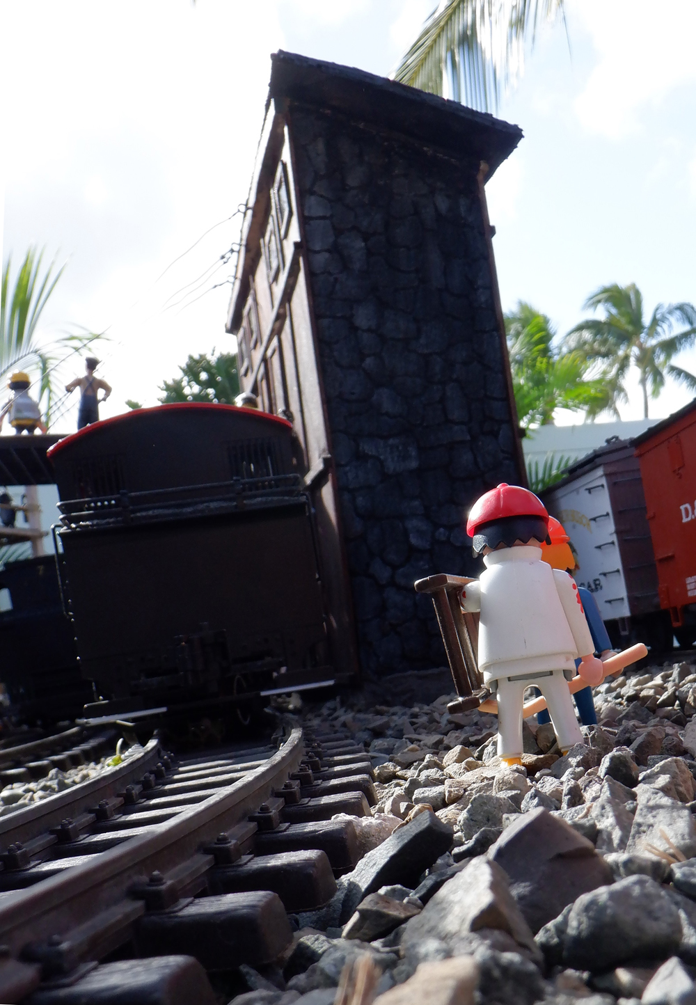 two figures walking trackside on garden railway