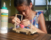girl concentrating on building piece of rolling stock