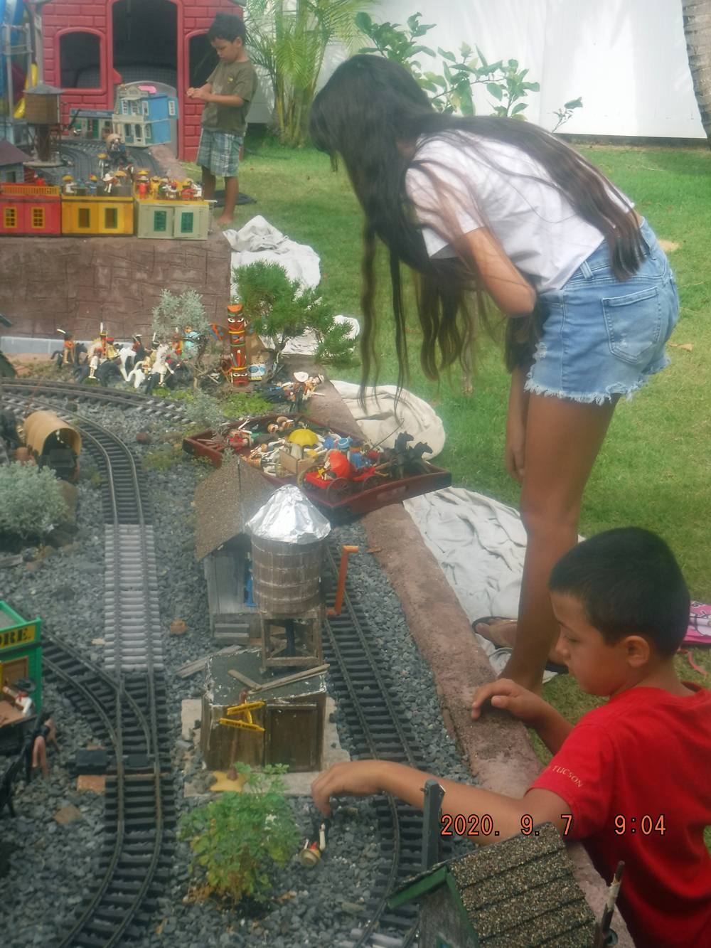 two children next to garden railway