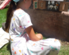 girl in dress next to model horse barn