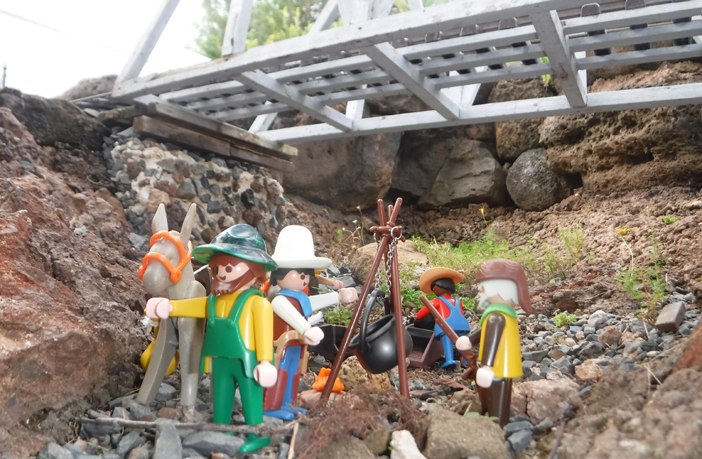 figures panning for gold on a garden railway